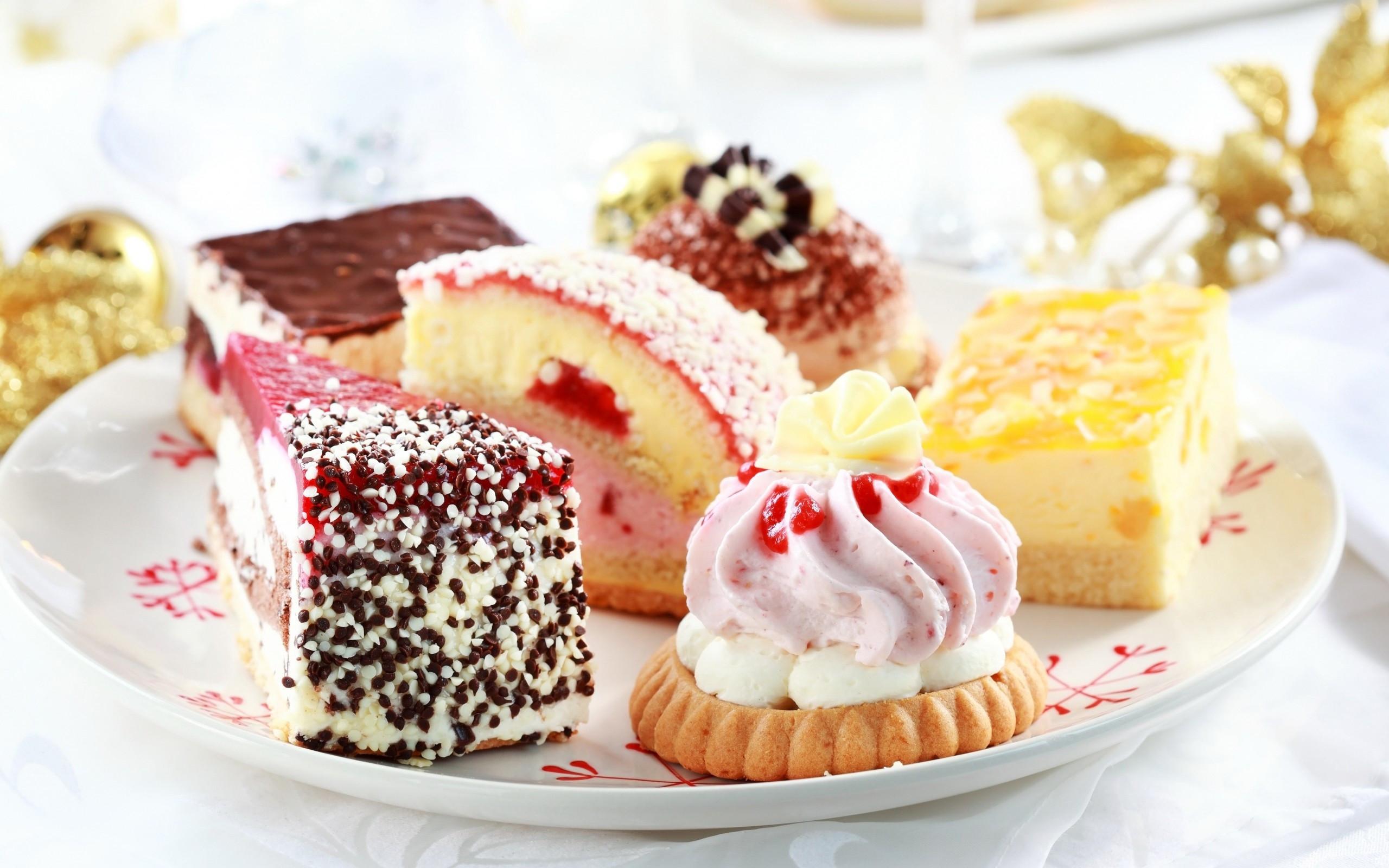 A variety of small cakes and cake slices
