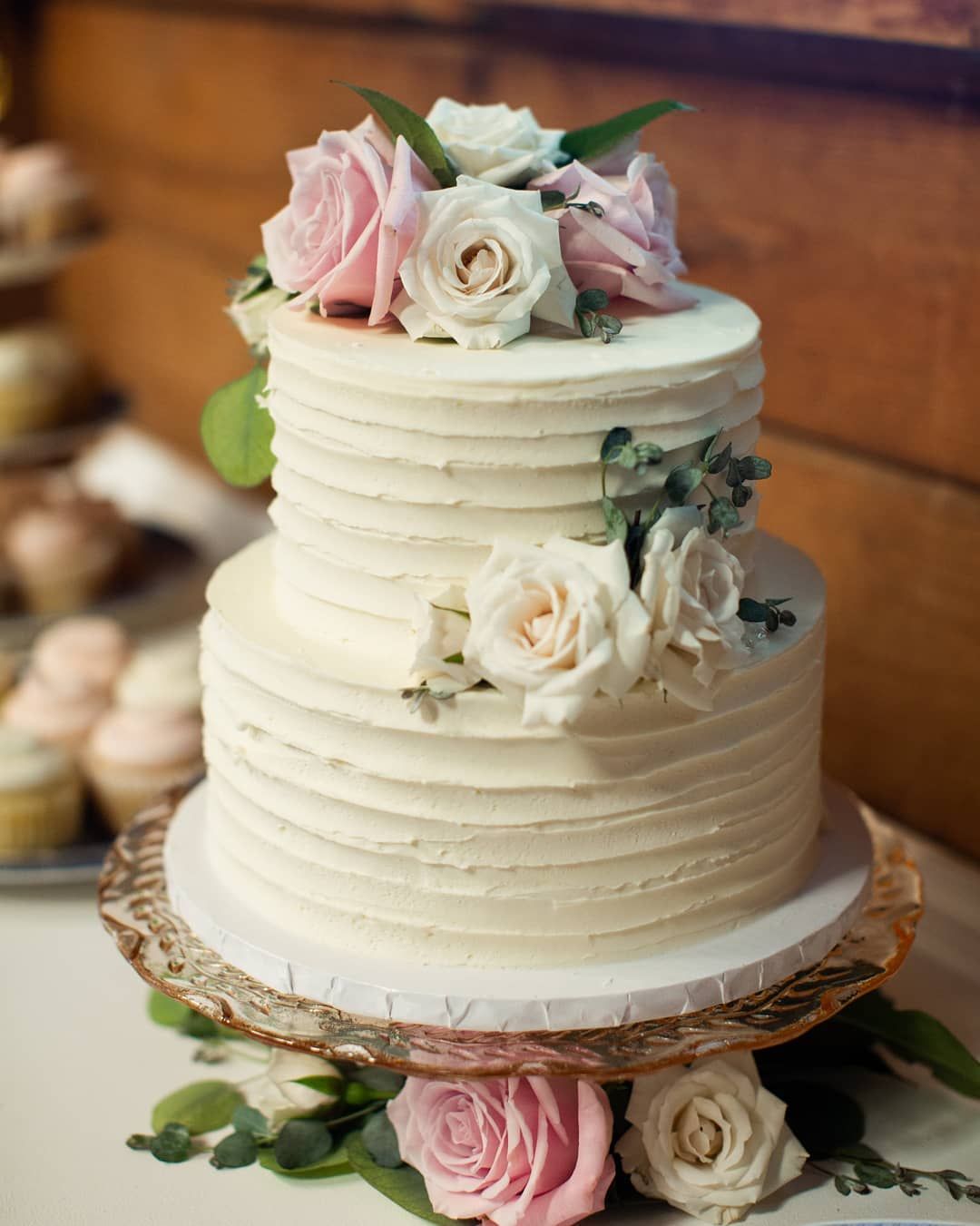 A two tiered wedding cake with realistic fondant roses